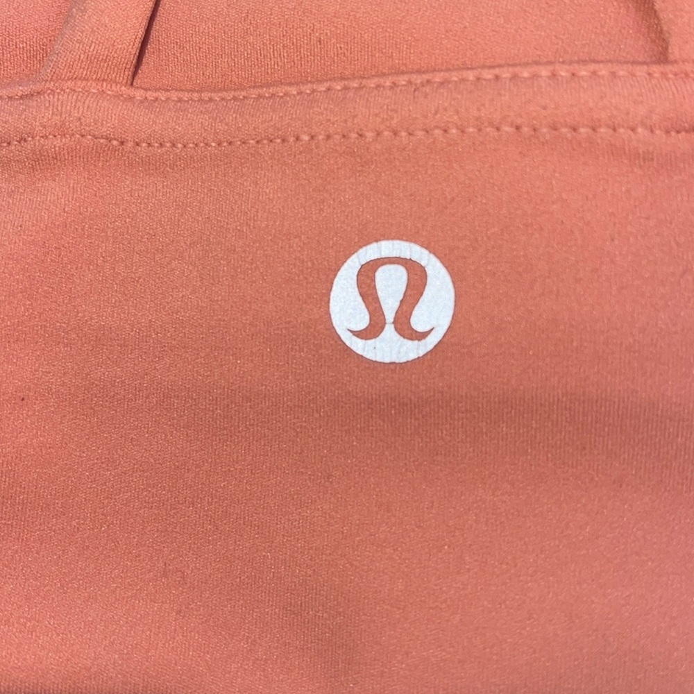 Lululemon Athletica peach/coral colored small sports bra.